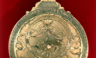 Gold Astrolabe on Red Background Photo