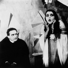 Cabinet of Dr. Caligari Film Still Showing Seated Man and Standing Distressed Woman